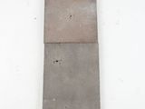 a close up of a piece of concrete on a white surface