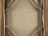 an old wooden frame with a picture hanging on it ' s side