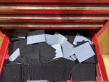 a red box filled with lots of black and white cards