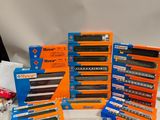a lot of different train tracks and boxes on the table