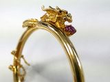 a close up of a gold ring with a dragon on it