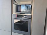an oven that is built into the wall in the kitchen