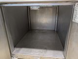 a metal box with a door open on the floor