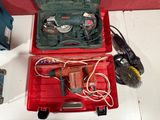 a red tool box with tools in it sitting on a table