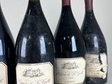 four bottles of wine are lined up on a table
