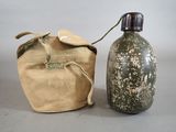 a bottle and a bag sitting next to each other on a table