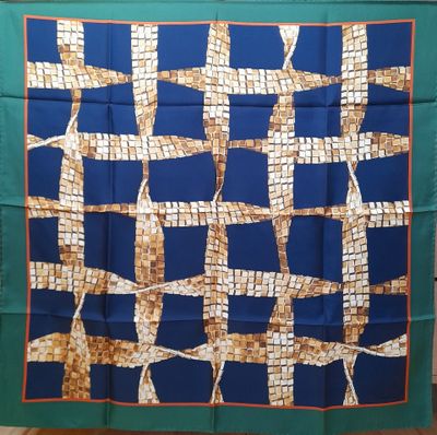 an image of a blue and brown square scarf hanging on a clothes rack