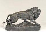 statue of a lion on a rock with a tag in its mouth