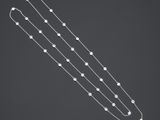 un long collier en argent orné de perles blanches et d'une longue chaîne en argent