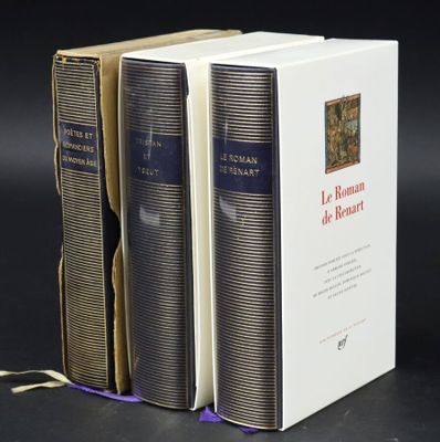 three books are stacked on top of each other on a table