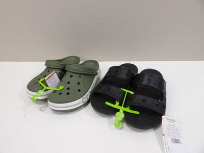 two pairs of crocs are sitting on a white table