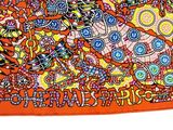 an orange scarf with a picture of a woman and a cat on it