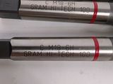 four different types of drill bits are lined up on a table