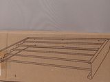 a cardboard box with a drawing of a bed frame on it