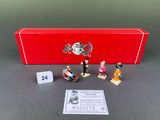 a red box with miniature figurines of people on it