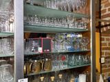 many glasses on the shelves in the room
