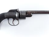 un gros plan d'un pistolet sur une surface blanche avec un fond blanc