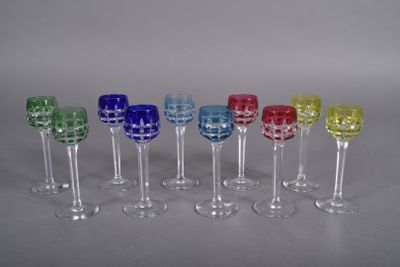 several different colored wine glasses are lined up in a row