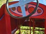 a red and blue toy car with a steering wheel