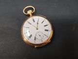 une montre de poche ancienne avec des chiffres romains sur un cadran noir