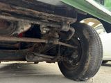 the rear end of a truck with a flat tire on the road