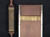 a wooden comb and a metal comb on a black background