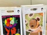 two boxes with pictures of animals on them sitting on a table
