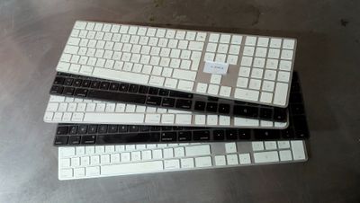 three keyboards sitting on top of each other on a table