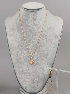 a white mannequin with a necklace and earrings on it