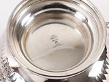 a silver cup that is sitting on a table