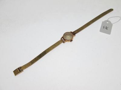 gros plan d'une montre sur une surface blanche avec une étiquette de prix
