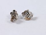 pair of silver and diamond earrings on a white surface