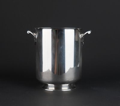 an antique silverplated ice bucket with handles on a black background