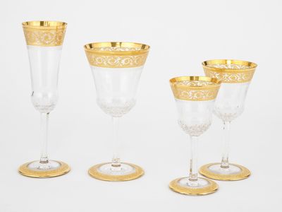 four gold rimmed wine glasses and a gold rimmed wine glass