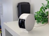 a small camera sitting on top of a white shelf