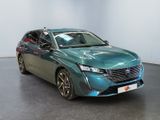 the green car is parked in a large room with a black floor
