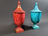 pair of red and blue vases sitting on a gray surface