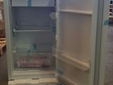 an open refrigerator that is sitting in a warehouse
