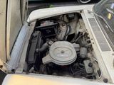 a small engine in the back of an old car