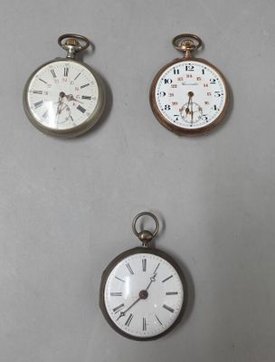 three different types of pocket watches are displayed on a table
