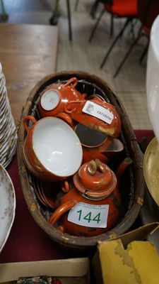 a basket full of plates and bowls on a table