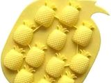 a yellow tray with pineapples on it on a white background