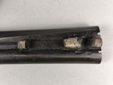 an old gun that is laying on a table