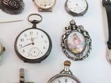 many different types of watches displayed on a table