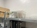 a metal shelf with a bunch of plates and bowls on it