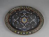 an oval platter with a floral design on it