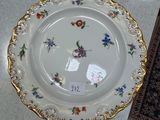a white plate with a floral design on it on a table