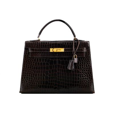 a black crocodile skin handbag with gold hardware