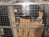 a cage with a bunch of bags inside of it