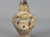 an image of a figurine of a woman holding a pot